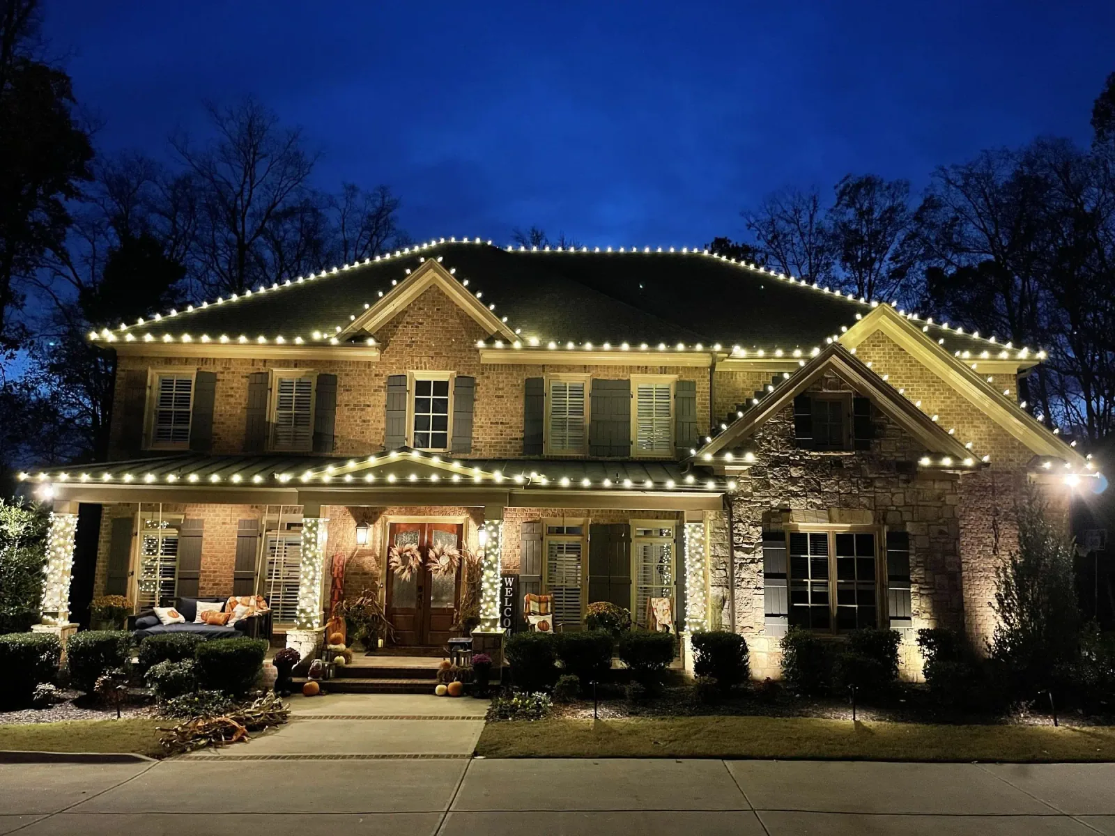 Professionally installed exterior holiday and permanent lighting on a residential home