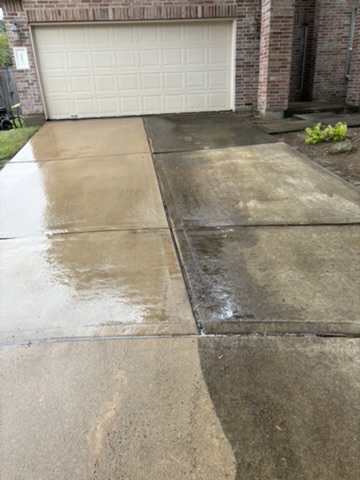 Professional surface-cleaning equipment mid-process on a concrete driveway