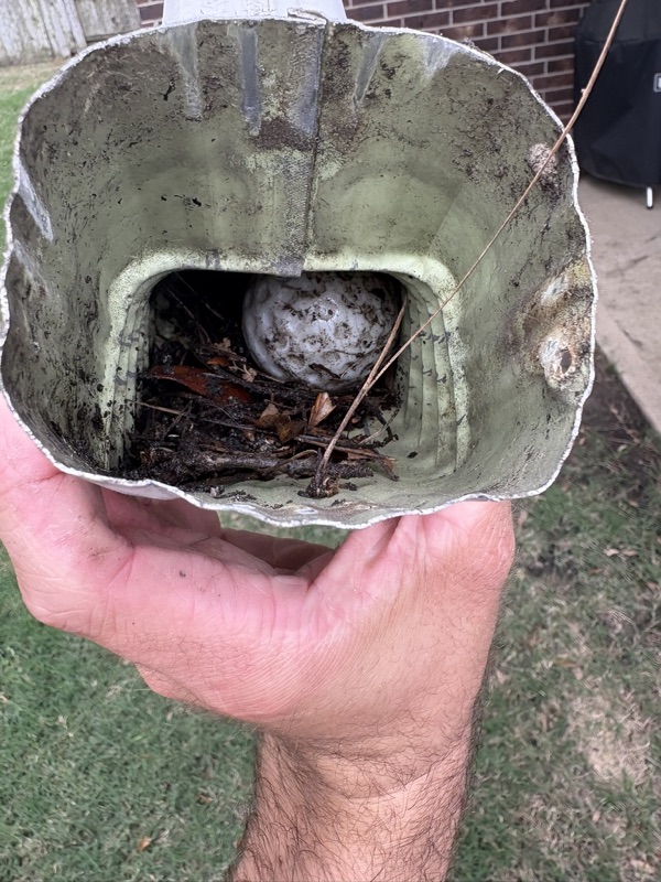 Debris cleared from a clogged gutter