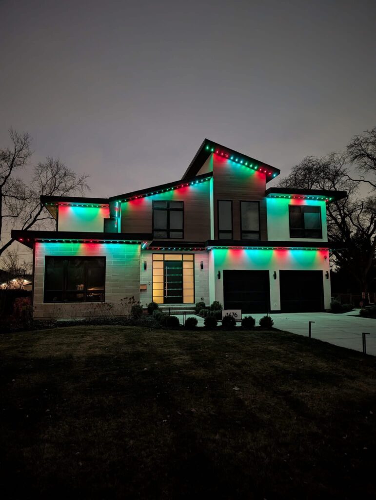 Permanent exterior LED lighting along the roofline of a modern home